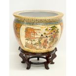 A large Japanese style pottery jardiniere on stand. 32x33cm.