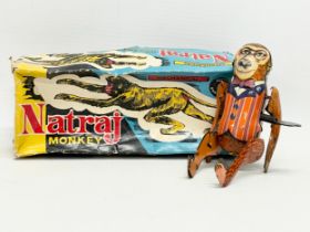 A vintage mechanical tinplate flipping Natraj Monkey in original box.