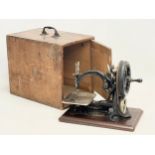 A rare early 20th century Willcox & Gibbs sewing machine in original carrying case. Circa 1900-1905.