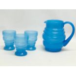 A vintage 4 piece bubble glass drinks set. Jug measures 19x18cm. Glasses 11cm