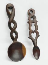 A vintage Welsh Love Spoon and a carved wooden serving spoon.