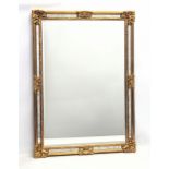 A large ornate gilt framed bevelled mirror. 68x94cm