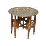 An early 20th century Burmese folding table with brass top. Circa 1900. 54x46cm.