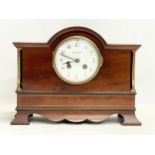 A late Edwardian inlaid mahogany mantle clock with brass mounts, key and pendulum. Riddles