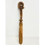 A late 19th century North European carved fruitwood letter opener. 28cm