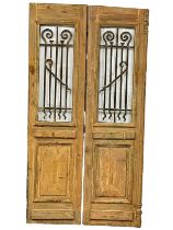 A pair of large 19th century French pine chateau doors with wrought iron Neo Gothic and glass