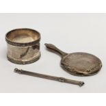 3 pieces of silver. Including a silver napkin ring stamped D. S., 1939, miniature silver mirror