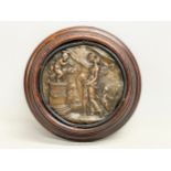 A 19th century bronze wall plaque in wooden frame. 18cm