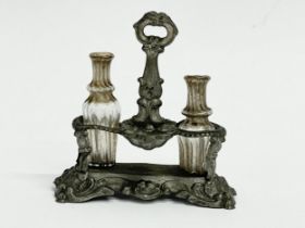 A Victorian dolls house decanter holder with original glass decanters. 4.5x5cm