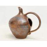 An unusual glazed pottery jug in the manner of Kurt Tschörner Ruscha. 14x14cm
