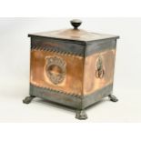 A Victorian copper coal bin with liner and lion paw feet. 35x35x41cm