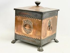 A Victorian copper coal bin with liner and lion paw feet. 35x35x41cm