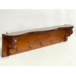 A late Victorian mahogany wall hanging hat and coat rack. 118x13x25cm