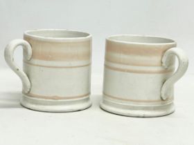 A pair of Victorian glazed mugs. 14x10cm