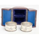 A pair of silver napkin rings in case. By Henry Wilkinson.