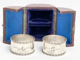 A pair of silver napkin rings in case. By Henry Wilkinson.