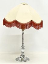 A 1930’s Art Deco chrome table lamp with shade. Base measures 32cm without shade.