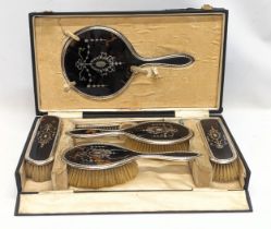 An early 20th century silver and faux tortoise shell vanity set in case.