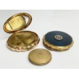 3 vintage compacts. A Kigu brass and enamel compact. A Kigu Minuette musical compact.