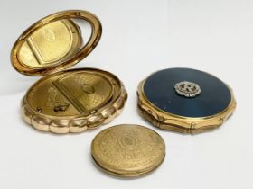 3 vintage compacts. A Kigu brass and enamel compact. A Kigu Minuette musical compact.