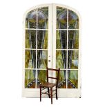 A pair of very large early 20th century Art Deco ornate stained glass arched doors. each door