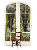 A pair of very large early 20th century Art Deco ornate stained glass arched doors. each door