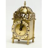 A vintage brass clock by Smiths Industries Limited. 17cm