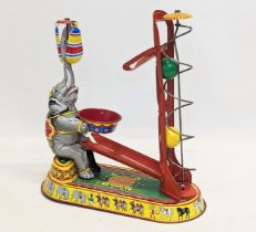 A vintage tinplate clockwork circus elephant, in working order. Made in US Zone, Germany. 21.5x24.
