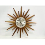 A Mid Century teak ‘Sunburst’ wall clock by Eurastyle. 48cm