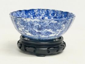 A 19th century Japanese blue and white porcelain bowl on stand. Bowl measures 16x6.5cm