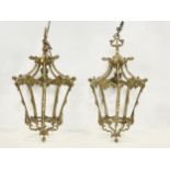 A pair of vintage ornate brass ceiling light fittings. 91cm including chain. Frames measure 23x43cm