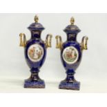 A pair of large early 20th century Neoclassical style ‘Royal Vienna’ porcelain urns with lids by