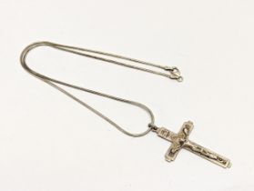 A silver necklace with crucifix pendant
