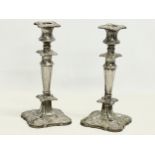 A pair of early 20th century ornate silver plated candlesticks. 25cm