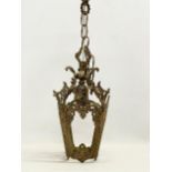 A vintage ornate brass ceiling light. 50cm including chain.