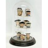A collection of miniature character jugs in domed display case. 29cm