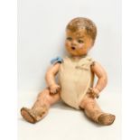 An early 20th century doll. 35cm