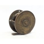 A late 19th / early 20th century brass fishing reel. 6.5x6.5cm