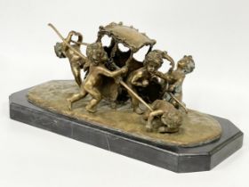 A large early 20th century ornate brass French Putti and carriage figure on marble base. In the