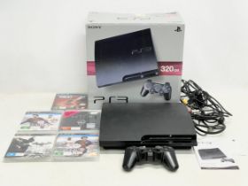 A PlayStation 3 (PS3) in box with controller, leads and games.