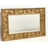 A large ornate gilt framed bevelled mirror. 100.5x65.5cm