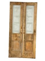 A pair of large 1920's Art Deco pine doors with glass panels. 109.5x223cm.