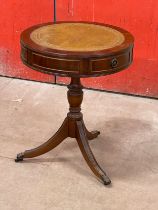 A mahogany leather top drum table with 2 drawers.