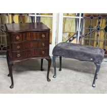 A mahogany chest with a modern stool