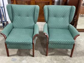 A pair of vintage wingback armchairs