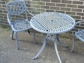 A cast alloy garden table and 2 chairs. 75x71cm