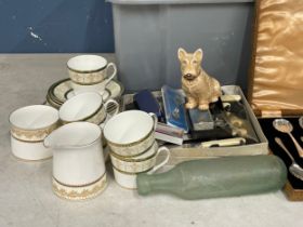A box lot of pottery, cutlery, dolls etc.