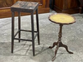 A leather top wine table and vintage stool.