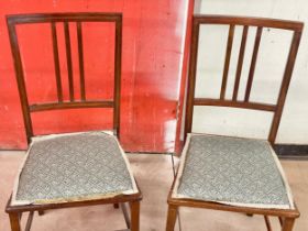A pair of Edwardian inlaid mahogany side chairs.