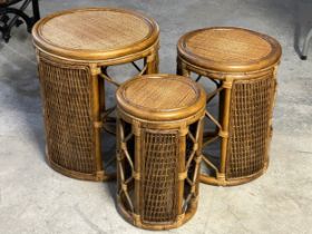 A wicker and cane nest of tables. Largest 46x54cm